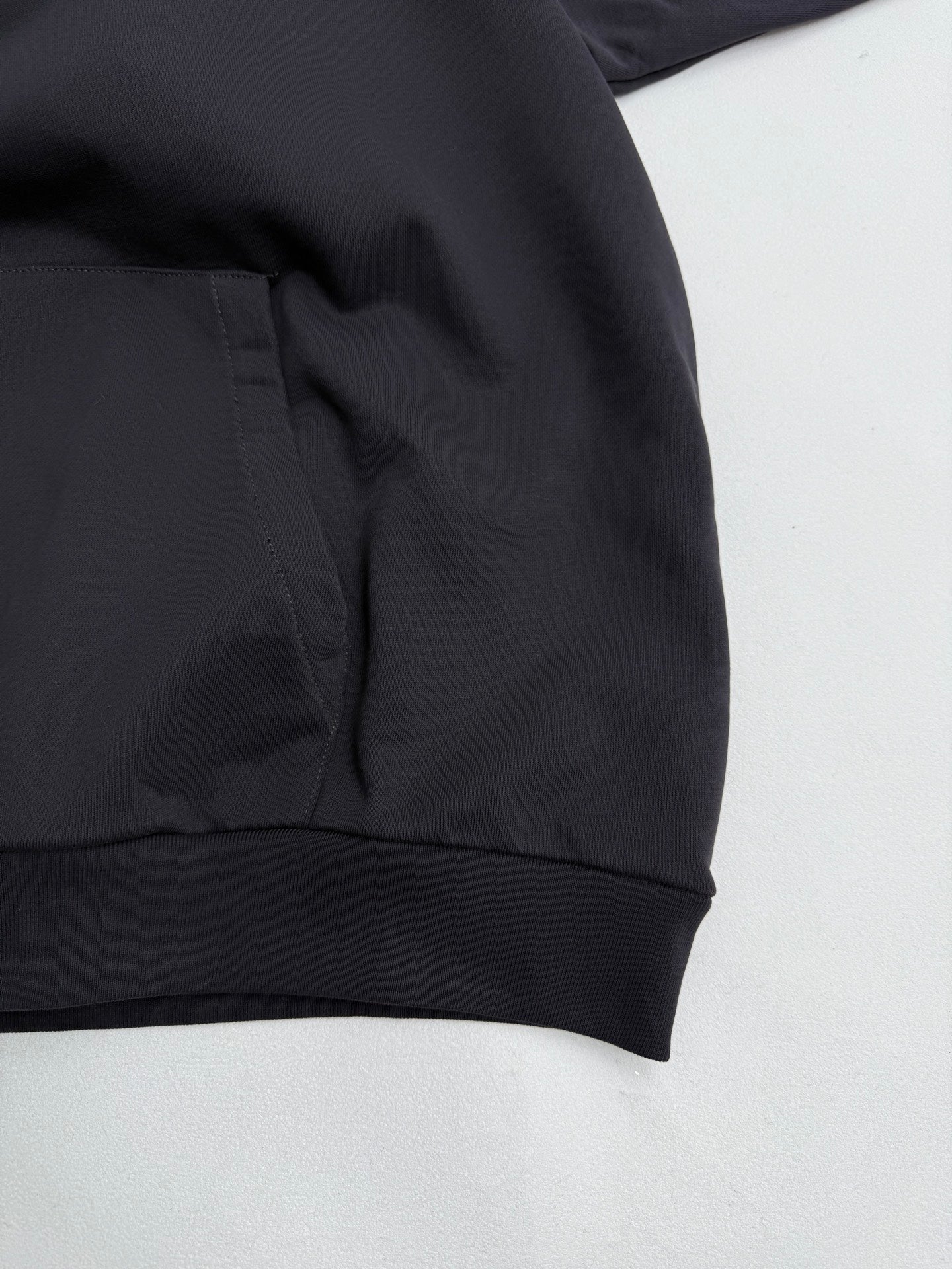 Black hoodie sweatshirt with kangaroo pocket and ribbed hem cuff