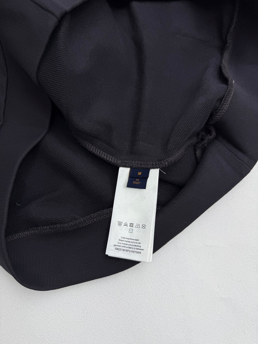 Black hoodie neckline with inner brand label and drawstring channel