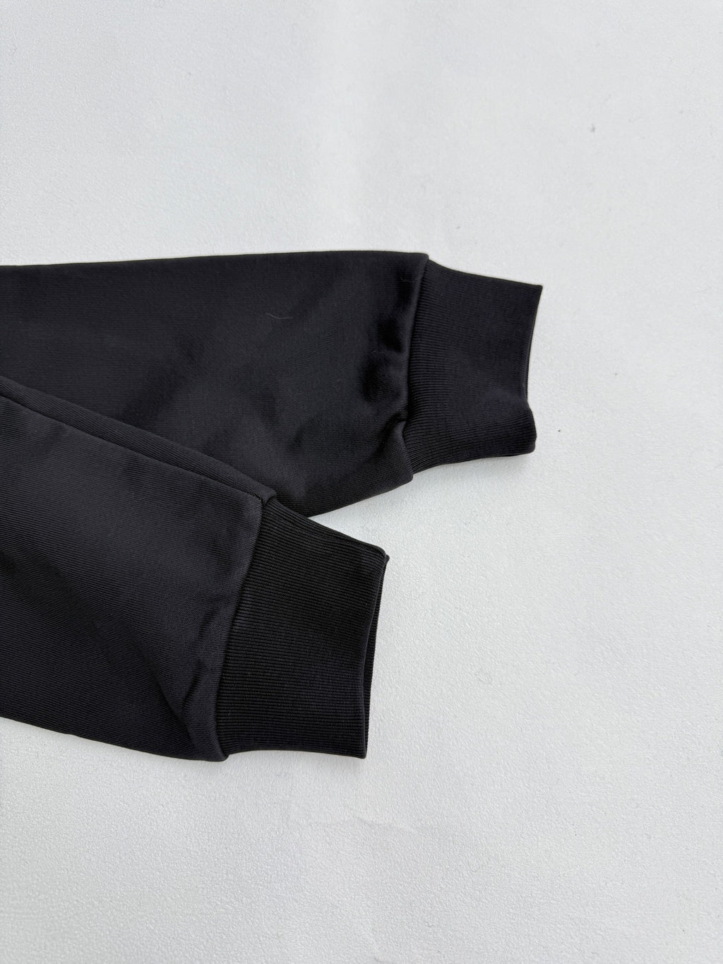 Black hoodie sleeve cuff and ribbed hem, folded detail