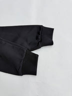 Black hoodie sleeve cuff and ribbed hem, folded detail