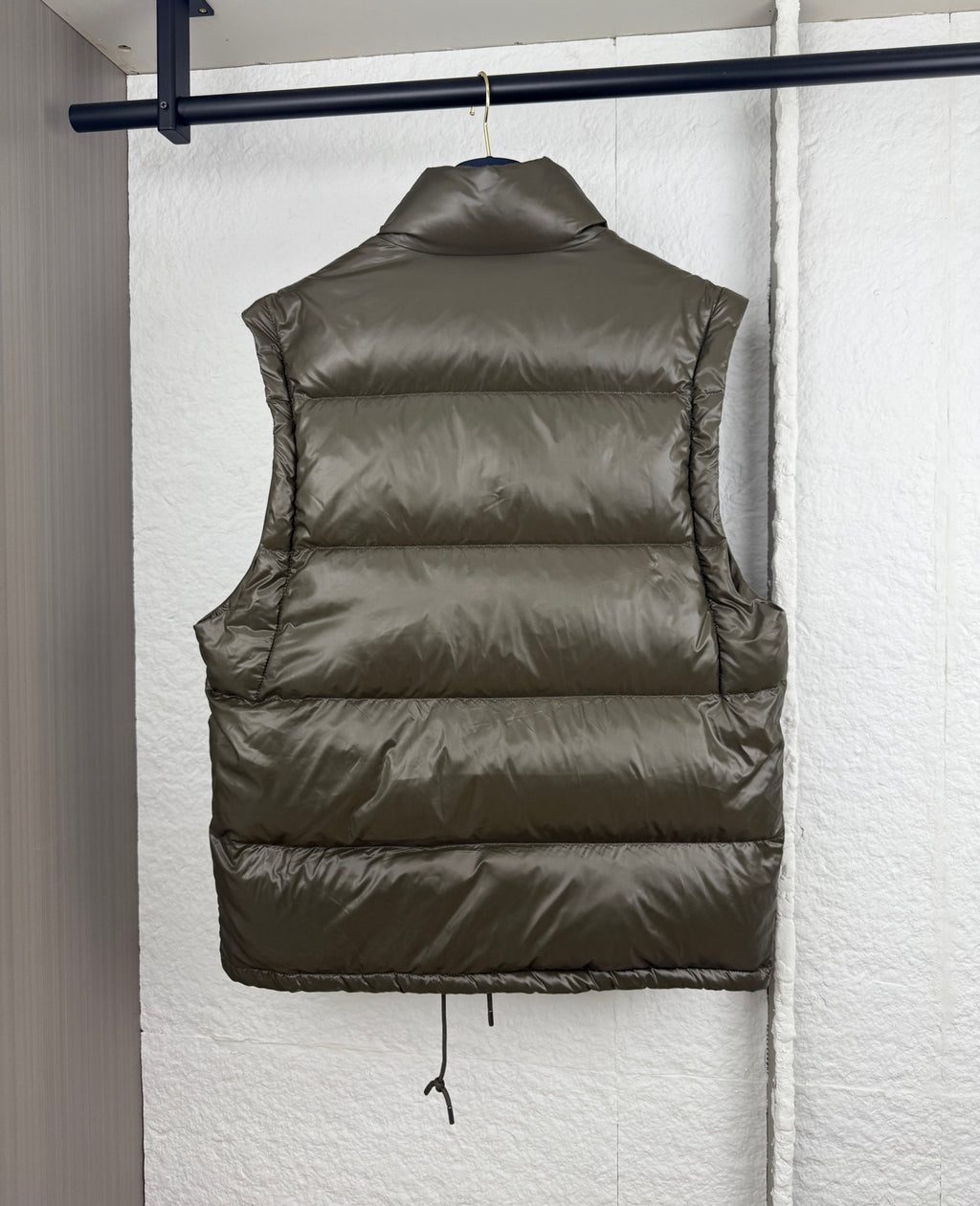 Prada long puffer vest back in olive with quilted panels and drawstring hem