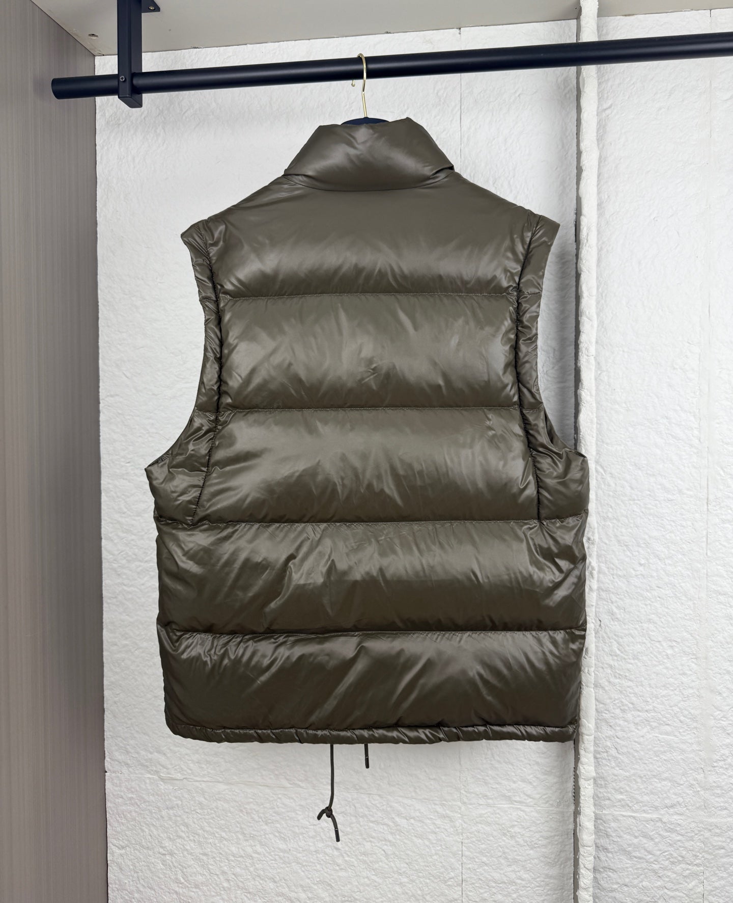 Prada long puffer vest back in olive with quilted panels and drawstring hem