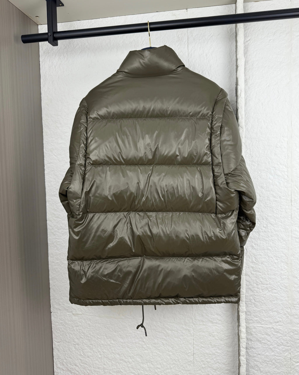 Prada long puffer jacket back view in olive with quilted horizontal panels