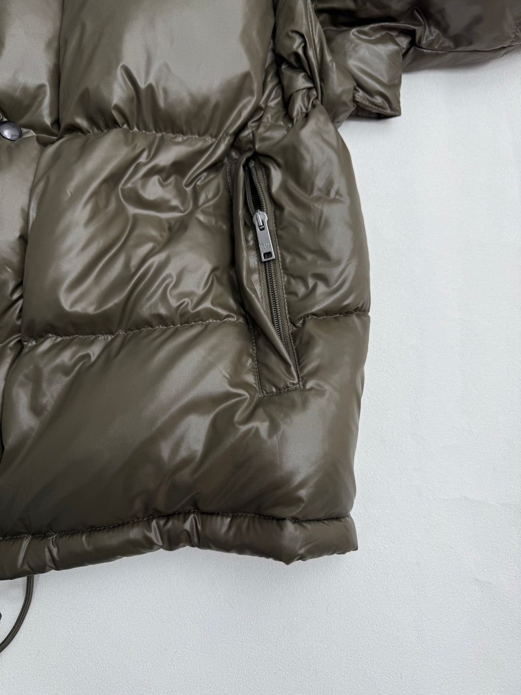 Prada puffer jacket with side zipper pocket and drawstring cord detail