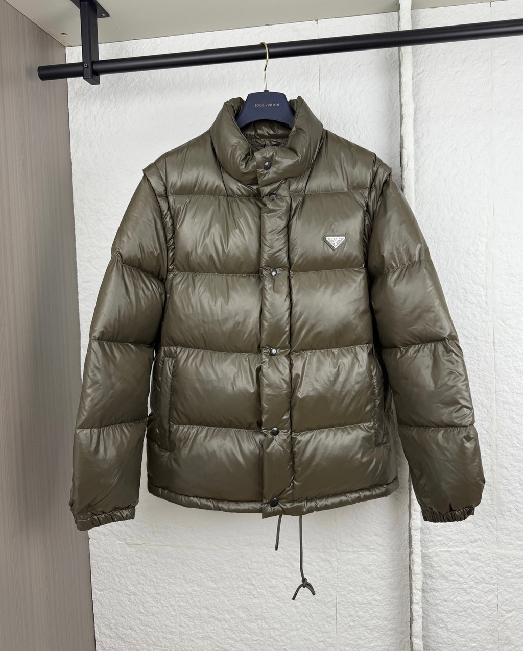 Prada long puffer jacket in olive with stand collar and button placket