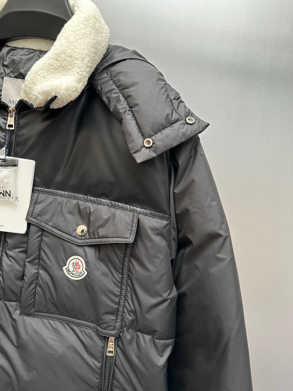 Moncler puffer jacket chest with snap pocket, logo patch, and faux shearling collar