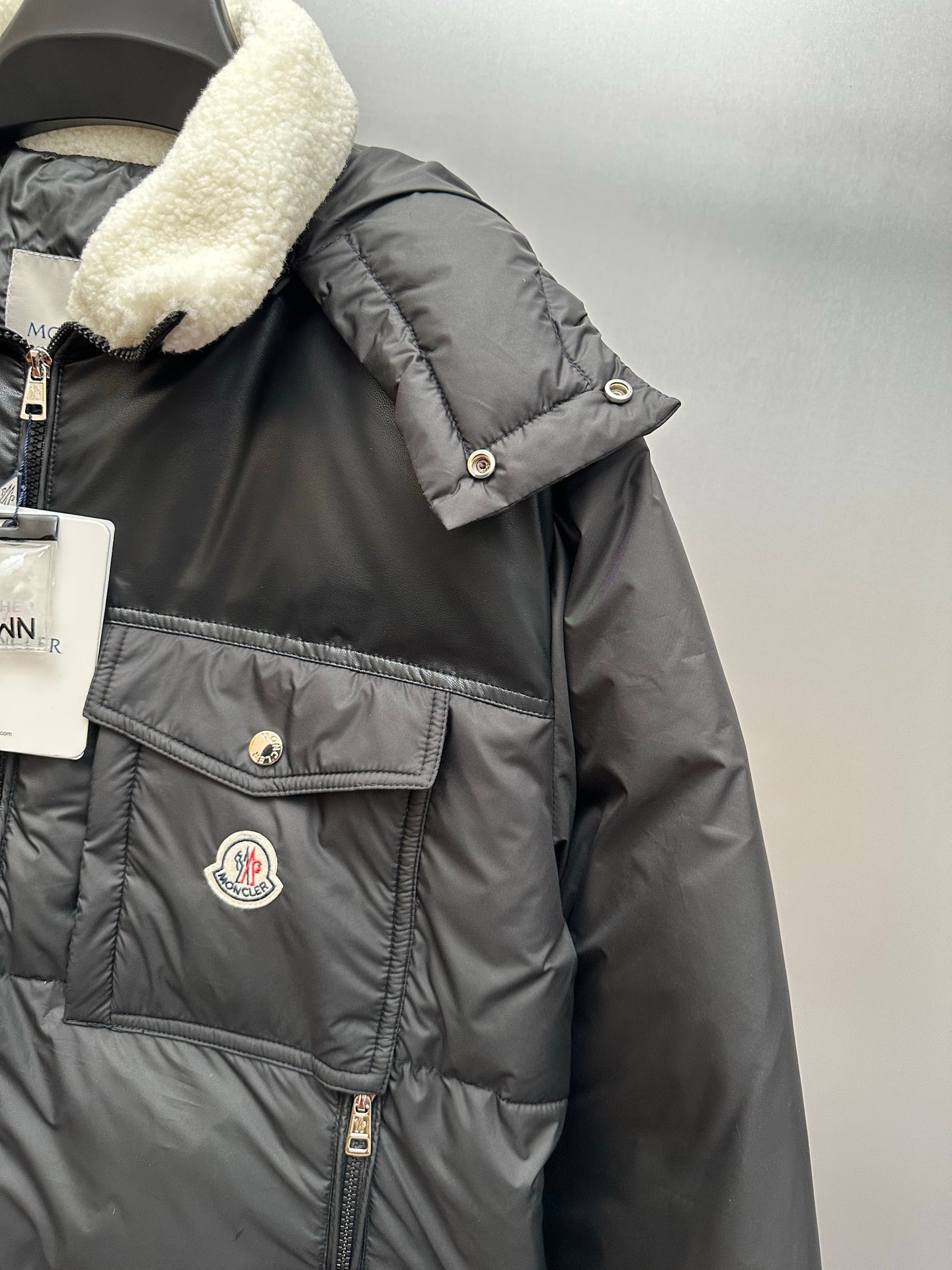 Moncler puffer jacket chest with snap pocket, logo patch, and faux shearling collar