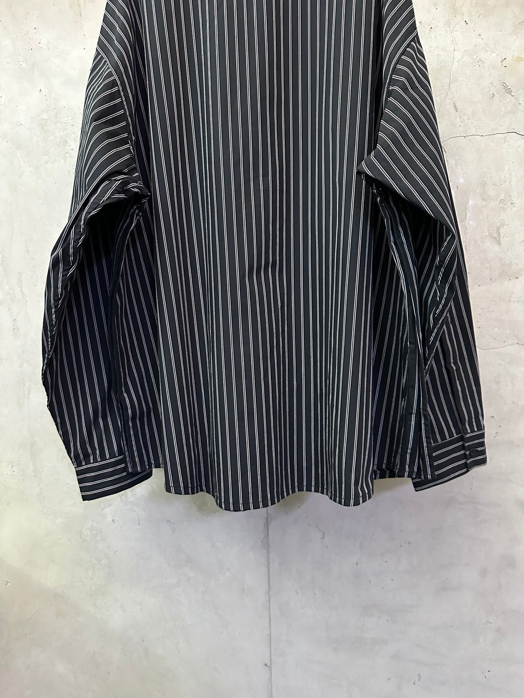 Long-sleeve striped button-up shirt, dark navy with white vertical stripes, cuff gathers