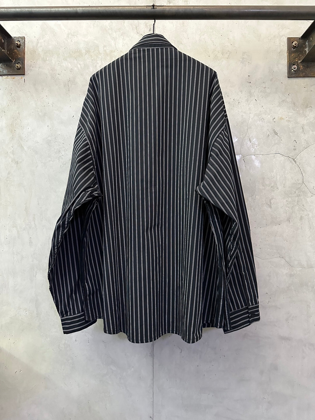 Long-sleeve striped button-up shirt, dark navy with white vertical stripes, back view