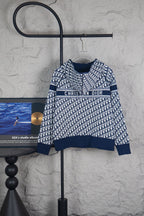 Dior long-sleeve knit sweater on hanger, navy and white monogram pattern, ribbed cuffs