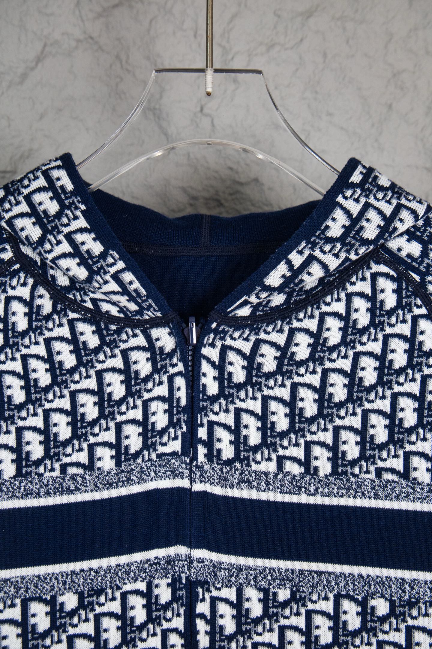 Dior long-sleeve knit sweater close-up, navy crew neck and monogram pattern