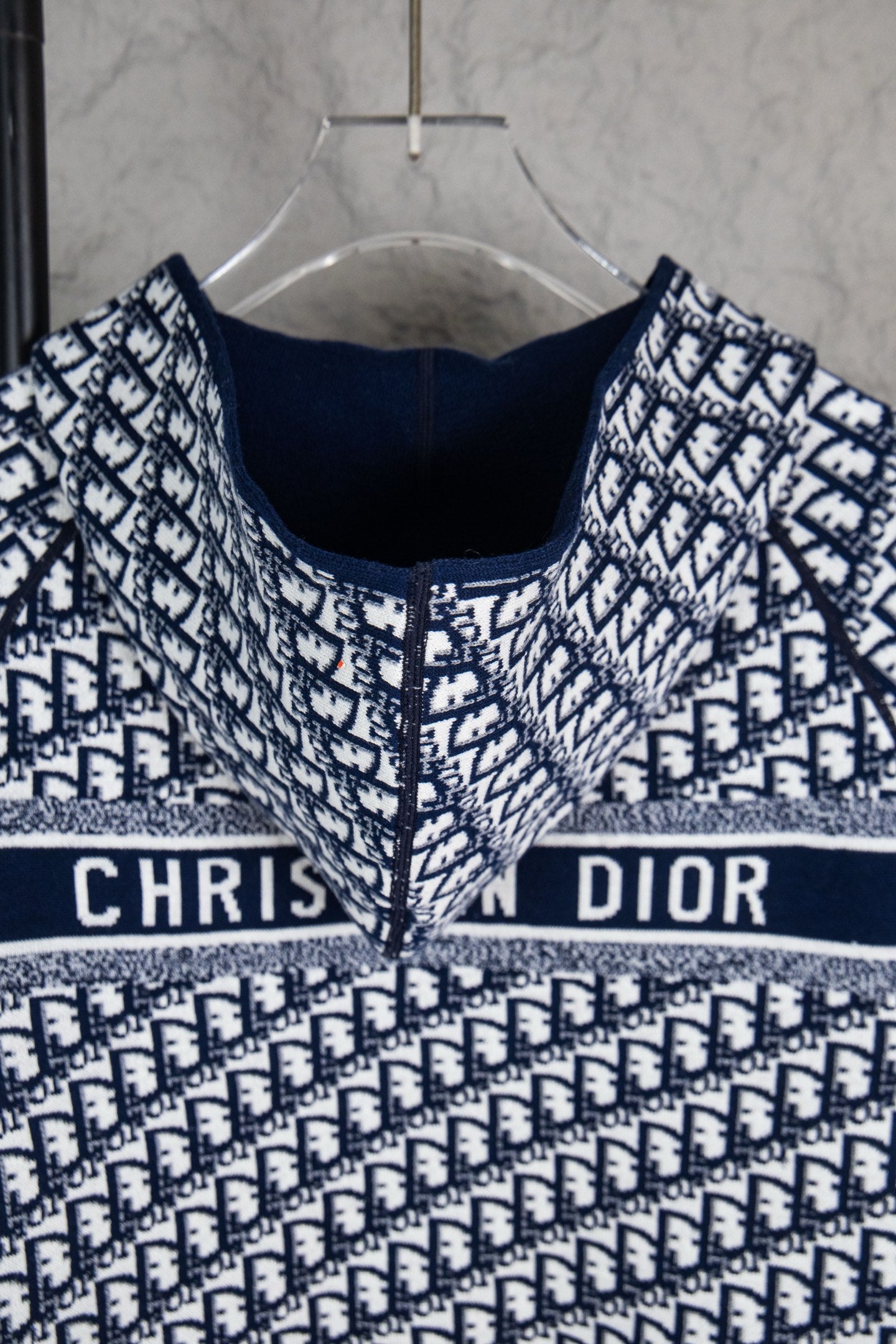 Dior long-sleeve knit sweater front view, navy crew neck and banded monogram design