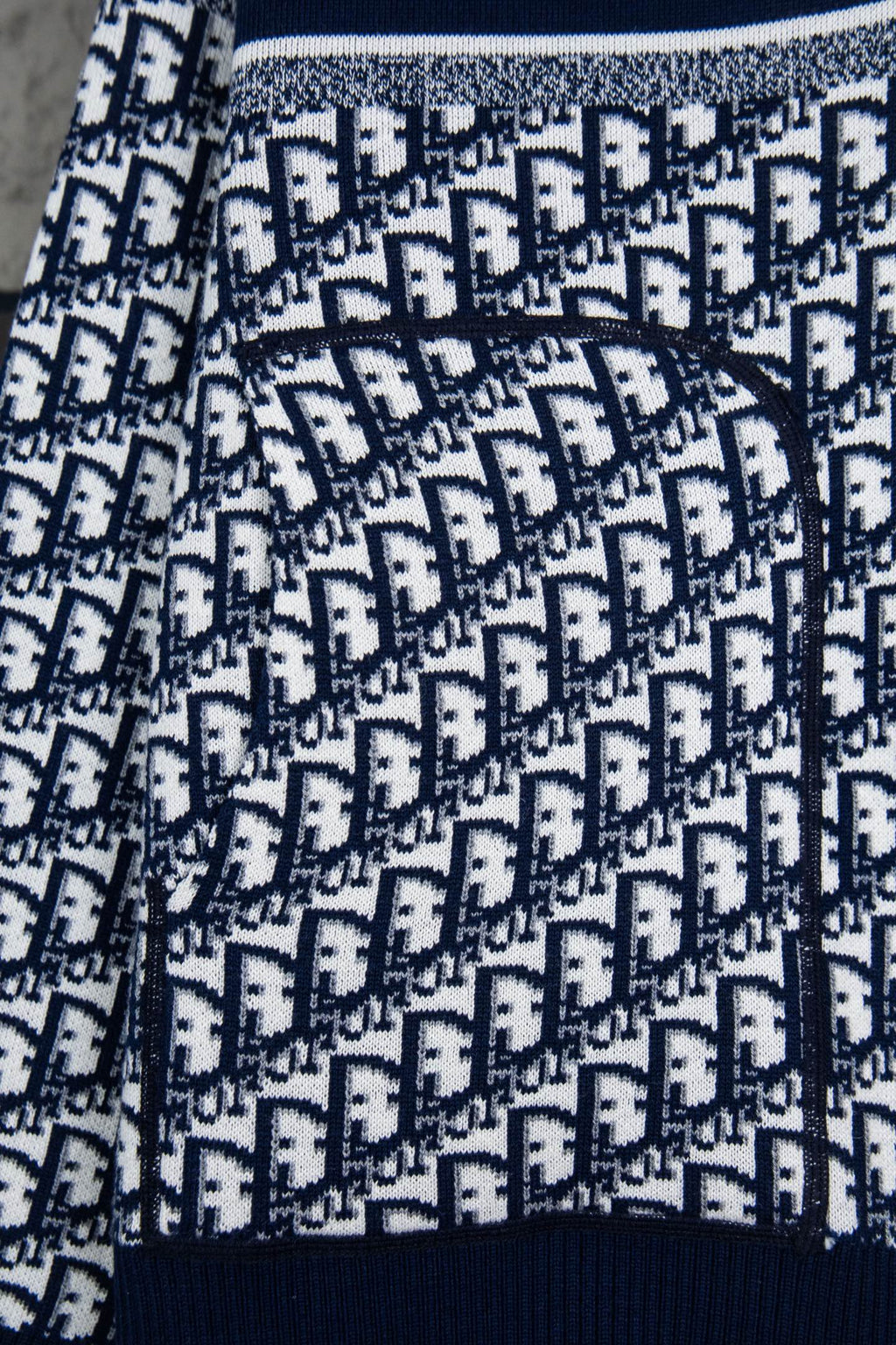 Dior long-sleeve knit sweater pattern close-up with navy ribbed cuff