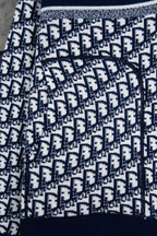 Dior long-sleeve knit sweater pattern close-up with navy ribbed cuff
