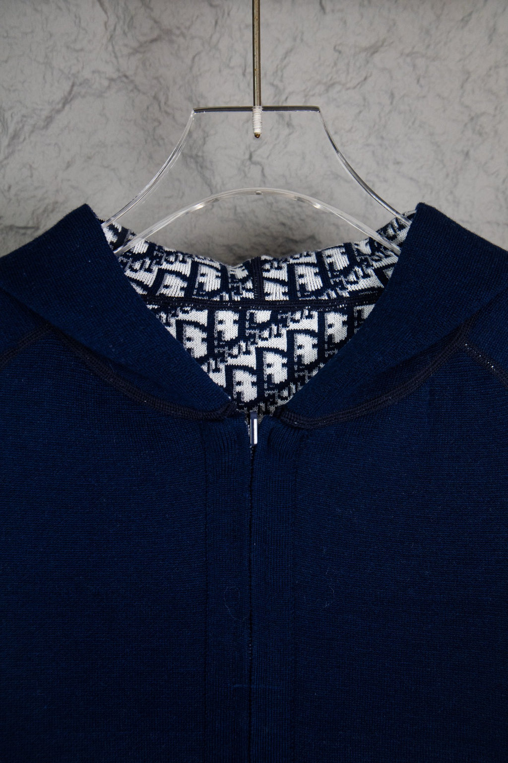 Navy Dior zip-up hoodie close-up at hood opening and front zipper