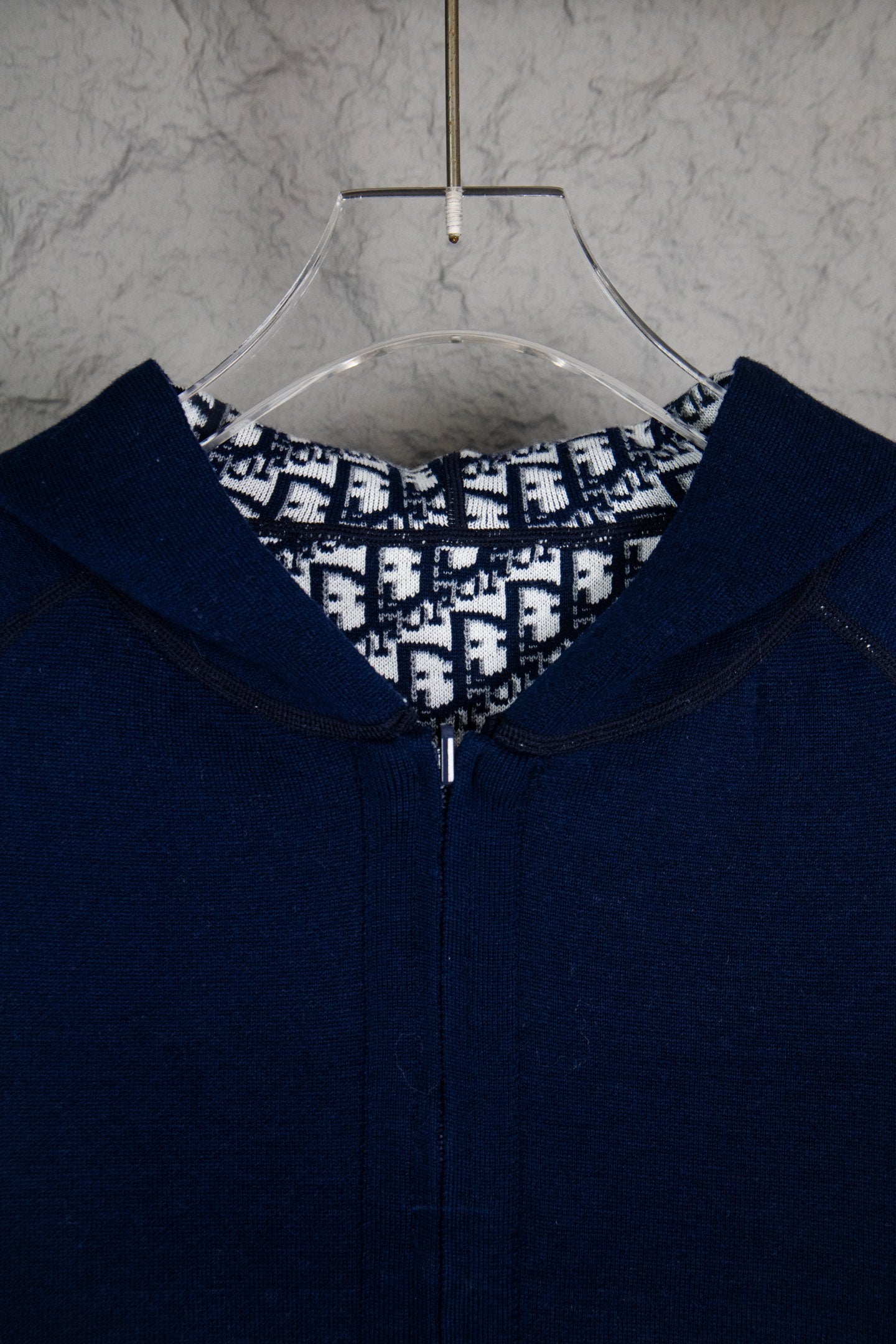 Navy Dior zip-up hoodie close-up at hood opening and front zipper