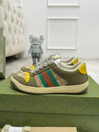 Gucci unisex low-top sneakers, olive upper with yellow heel tabs and green-red stripe