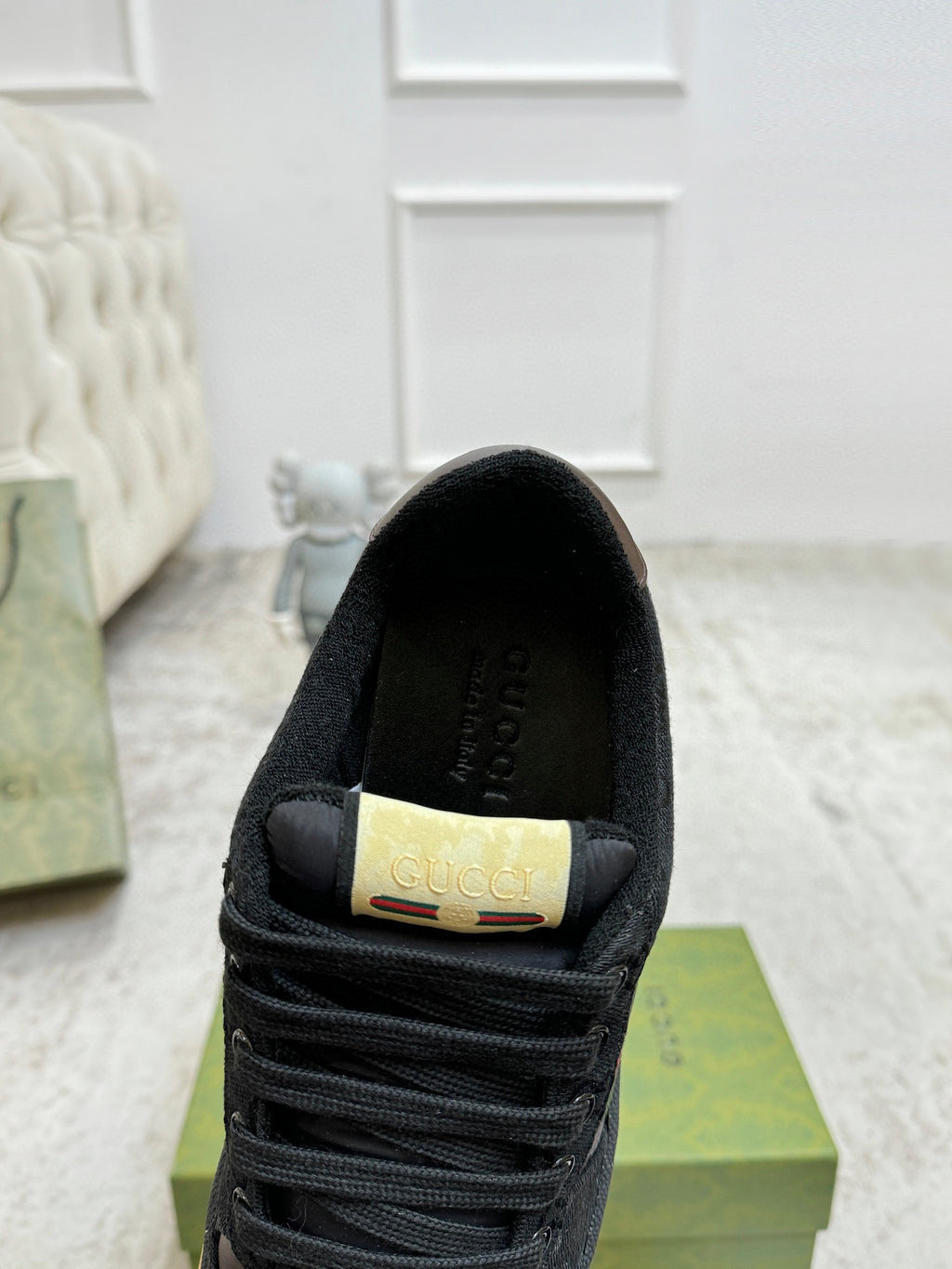 Gucci unisex sneaker heel with gold brand label and black lining