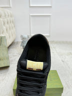 Gucci unisex sneaker heel with gold brand label and black lining