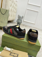 Gucci unisex sneakers with black uppers, red/green stripe, gold heel tab