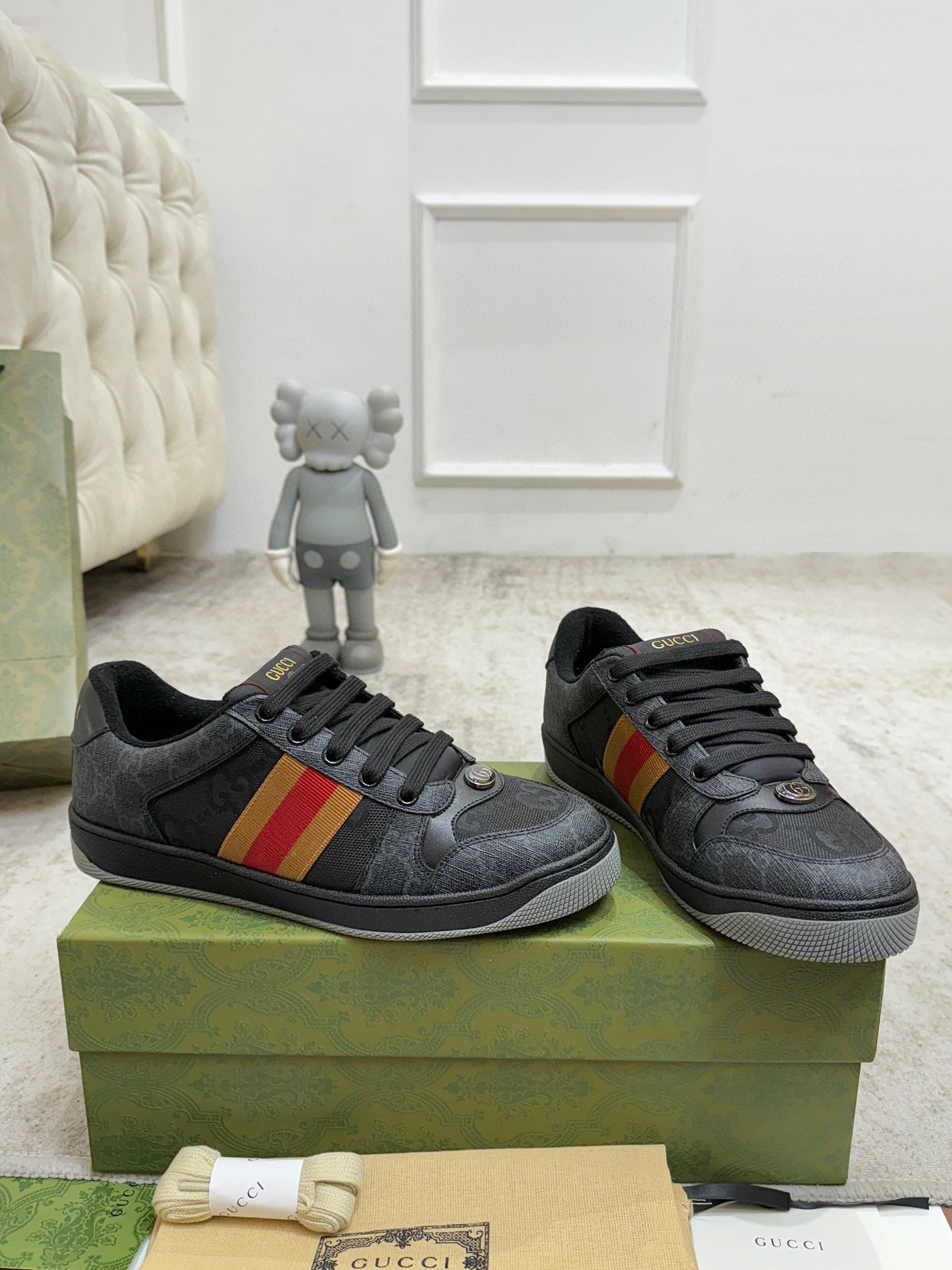 Gucci low-top sneakers, dark gray uppers with red-yellow-green stripe detail and black laces