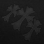 Close-up of embroidered floral-style logo on black hoodie fabric