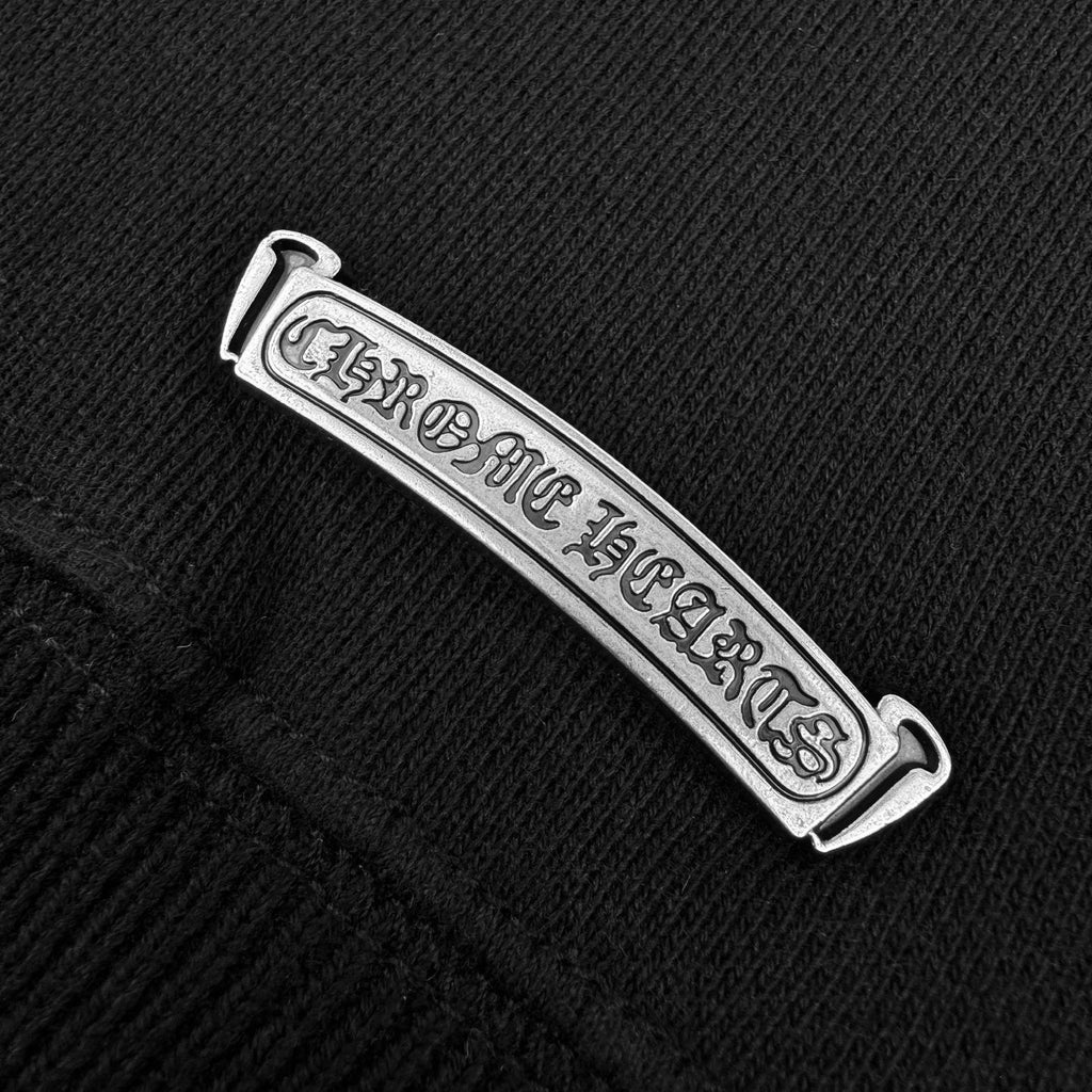 Metal logo patch label on black hoodie pocket