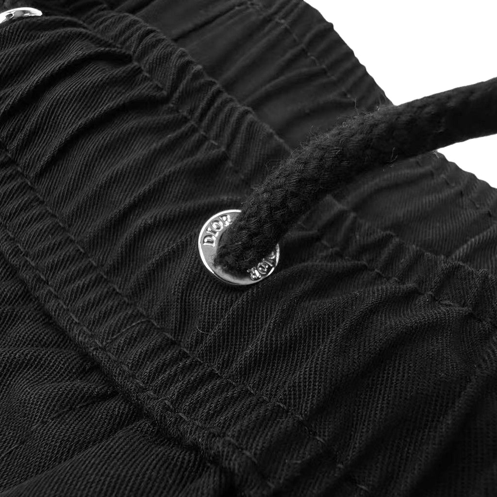 Dior metal shank button on black fabric waistband