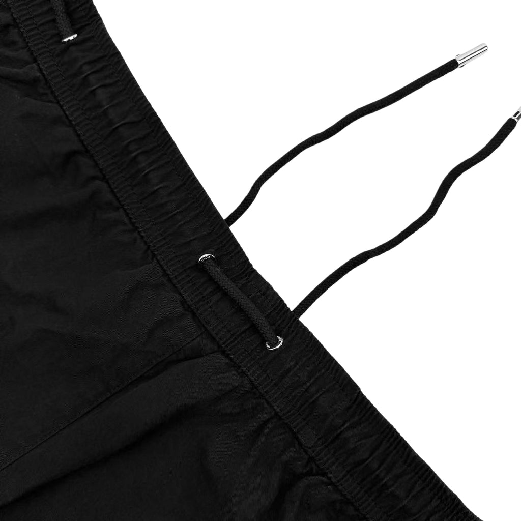 Black drawstring cords with metal tips on elastic waistband