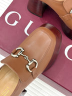 Gucci brown leather loafer strap detail with silver horsebit hardware on side