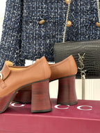 Gucci tan leather loafers side view with silver horsebit bar and stacked block heel