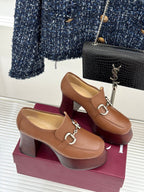 Gucci brown leather heeled loafers featuring silver horsebit trim and thick wooden heel