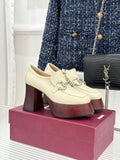 Cream Gucci platform loafers with metal horsebit detail and dark red block heels