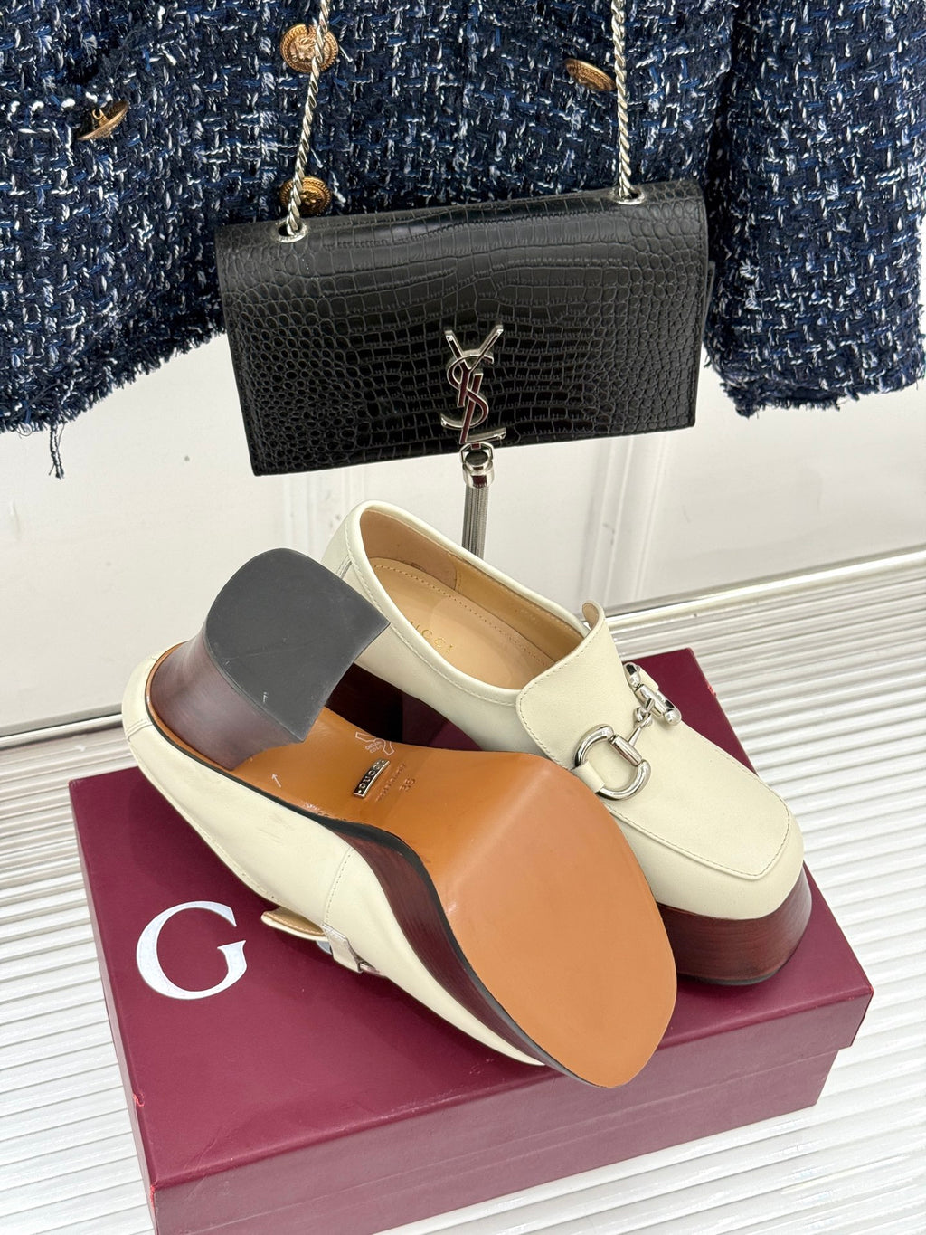 Cream Gucci loafers with metal horsebit detail, opened instep showing tan lining