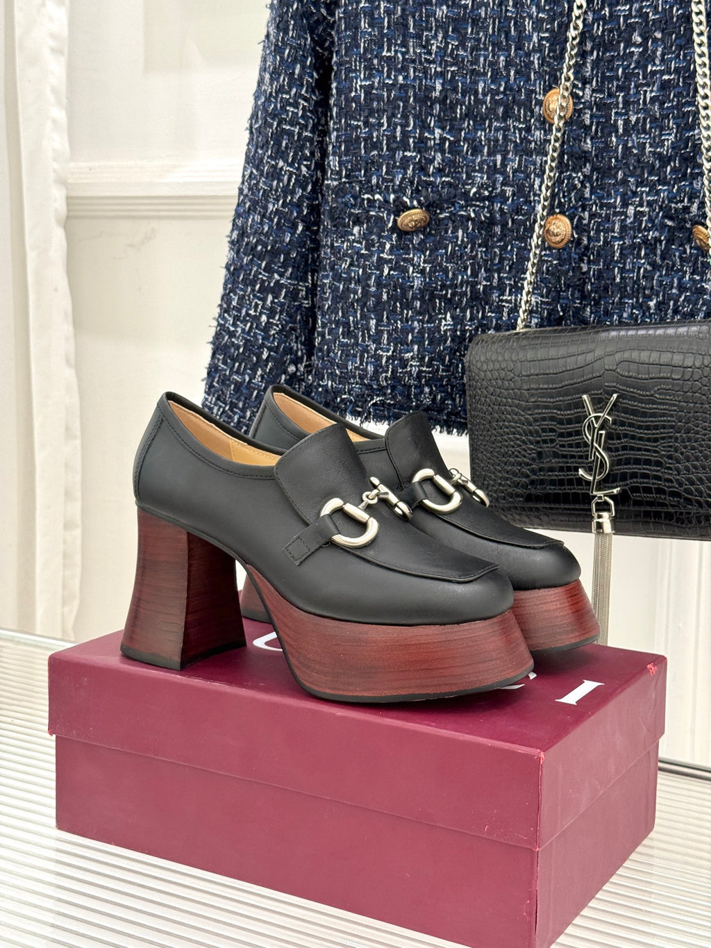 Black leather platform loafers with chunky block heels and silver chain hardware