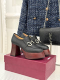 Black leather platform loafers with chunky block heels and silver chain hardware