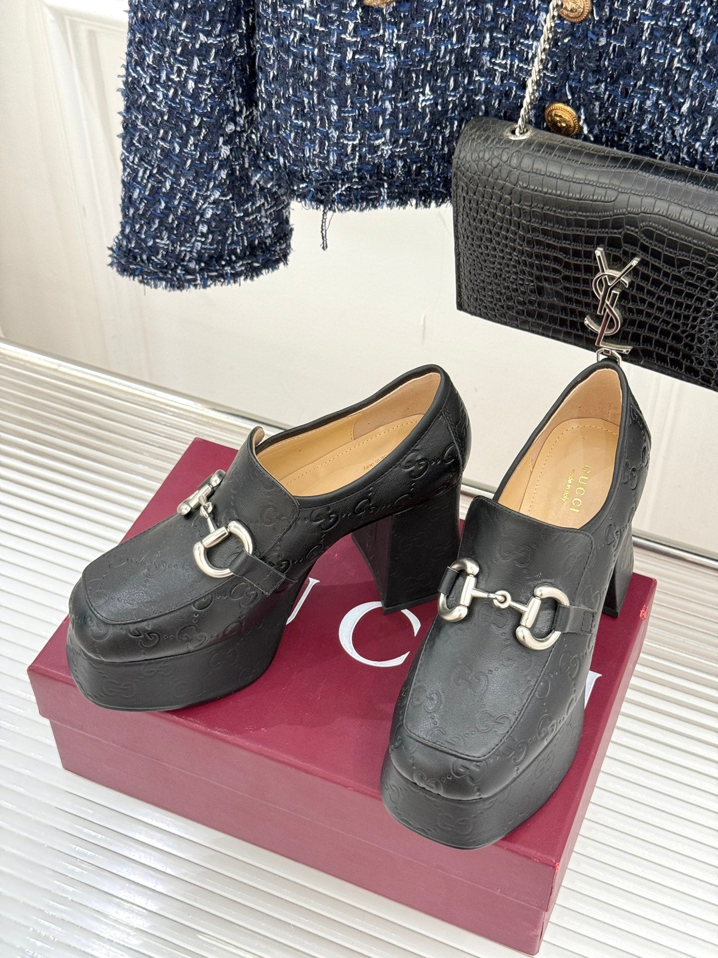 Black Gucci loafer platform heels, side view, with gold-tone bit hardware