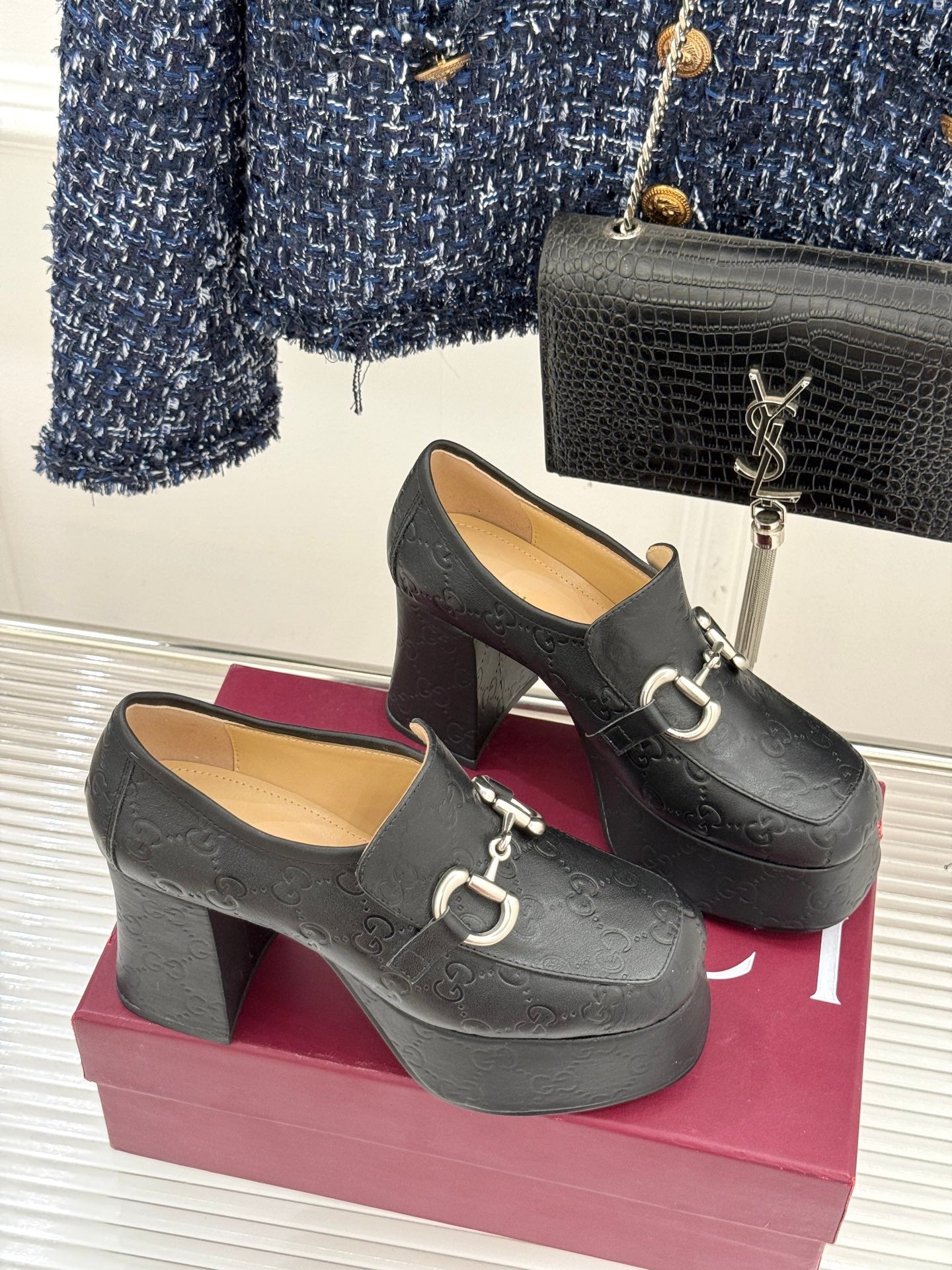 Black Gucci loafer platform heels, front view, with gold-tone bit hardware