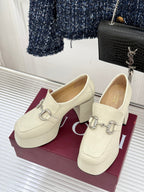 Cream leather loafers with silver horsebit detail and block heel, side view