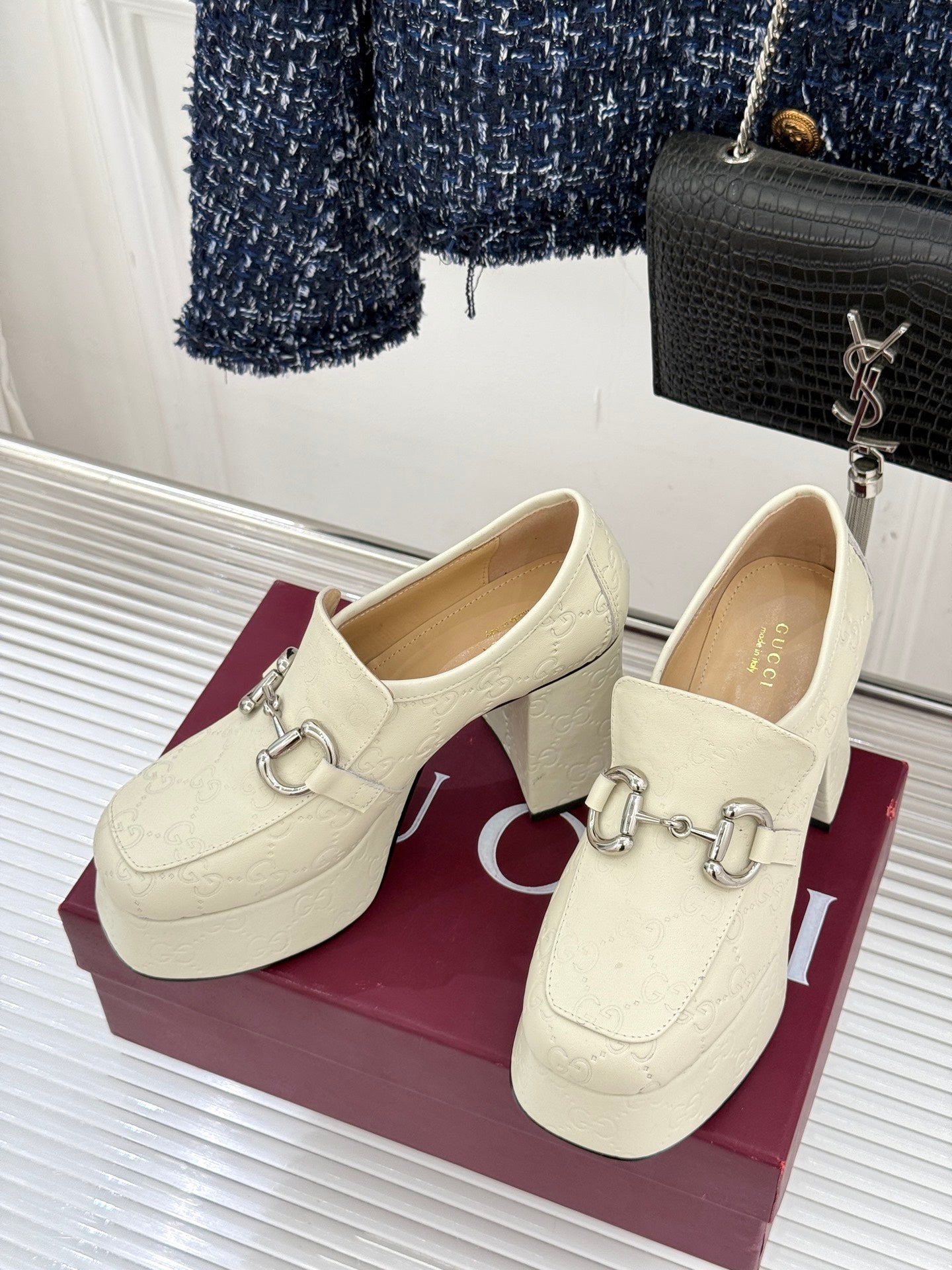 Cream leather loafers with silver horsebit detail and block heel, side view