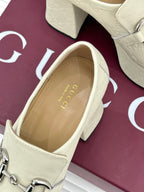 Cream leather loafer with silver horsebit, open heel and insole view