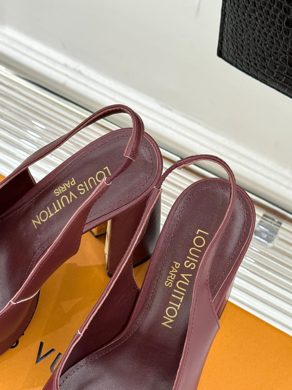 Burgundy leather high-heel slingback pumps with monogram logo on insole