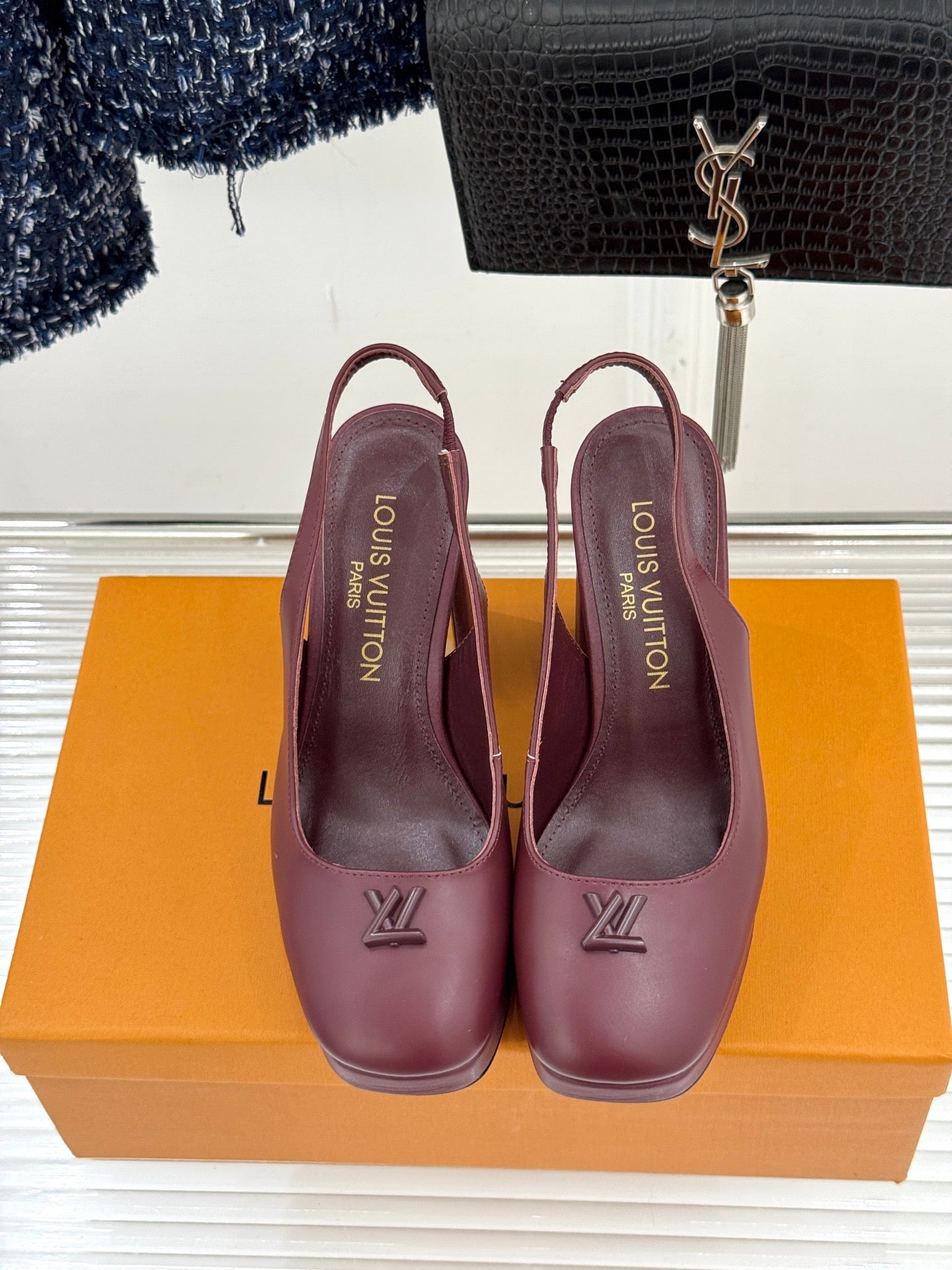 Burgundy leather high-heel pumps with monogram detail on front and back