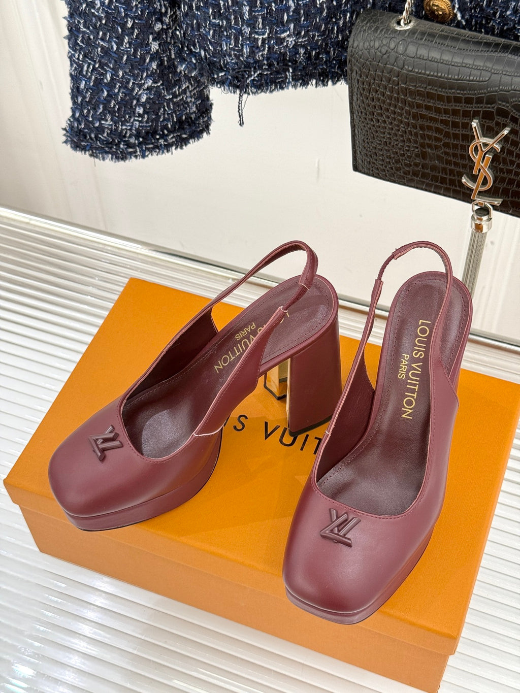 Burgundy leather high-heel slingback pumps with monogram detail on the side