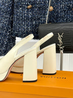 White Louis Vuitton leather pumps with squared block heel and V logo, side view