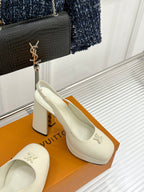 White Louis Vuitton leather pumps with block heel and embossed V logo