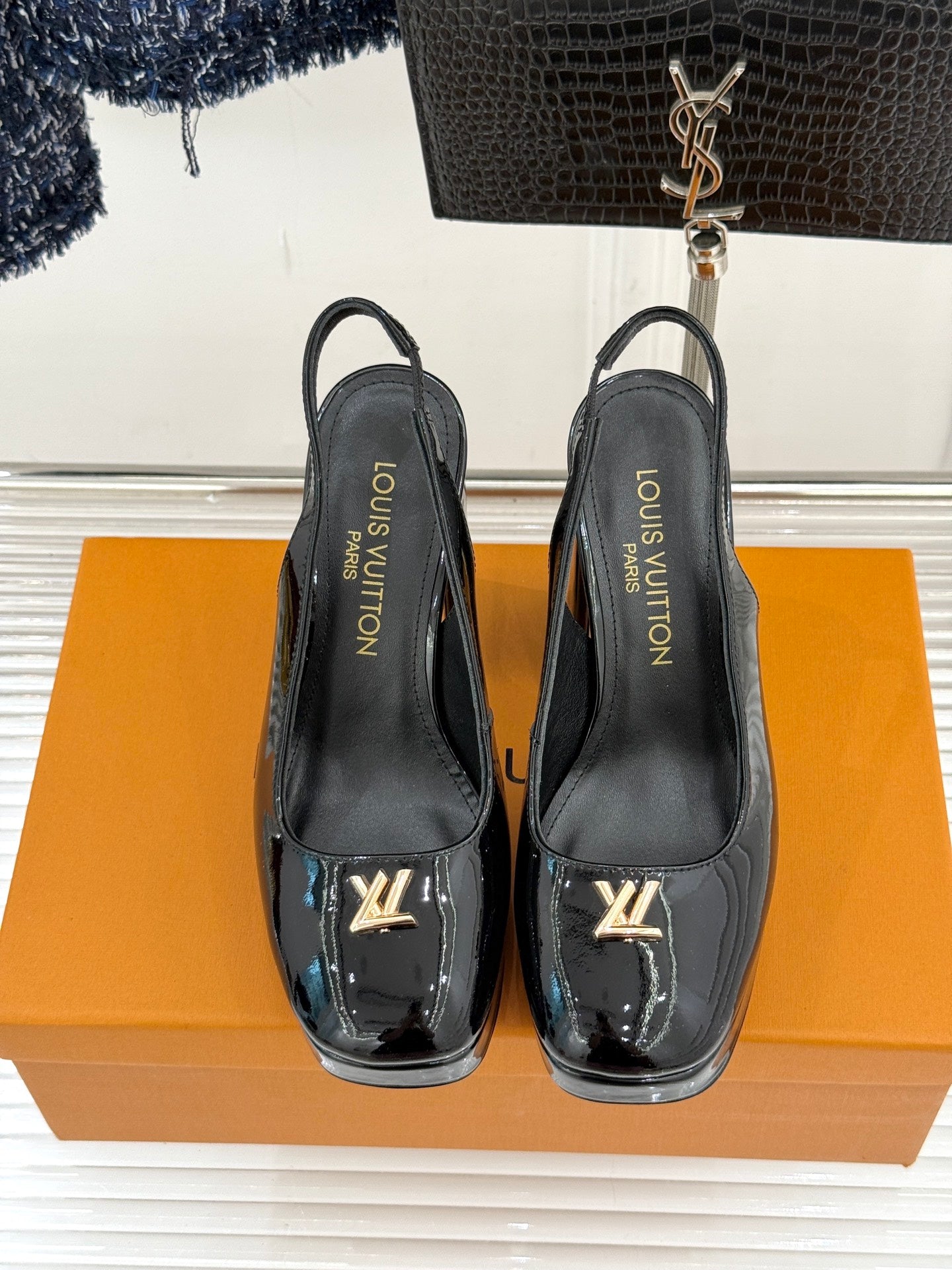 Black leather high-heel pumps with LV logo, pointed toe