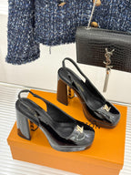 Pair of black patent leather high-heel pumps with LV logo on toe