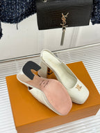 White patent leather high-heel shoes with gold LV logo and matching insole