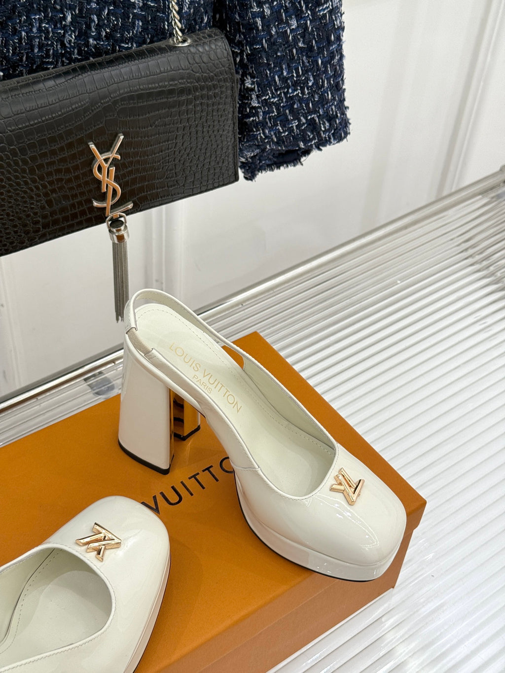 White patent leather high-heel slingback shoes with gold LV emblem